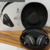 Meze 99 NEO headphones folded next to travel case