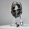 Meze Audio Elite headphones displayed on the signature Meze Manta Chrome stand