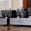 Cary Audio CAD-211FE monoblocks in a silver finish, integrated into a high-end audio system.