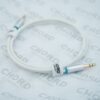 Close-up of a white audio cable with a blue 1/4-inch plug against a blurred backdrop with company branding.