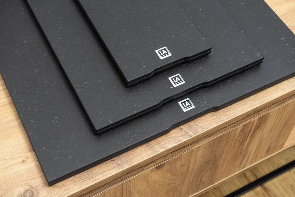 A stack of three different-sized Lehmannaudio 3S Base equipment platforms on a furniture. Choose size according to the footprint of audio component the Base will be used under