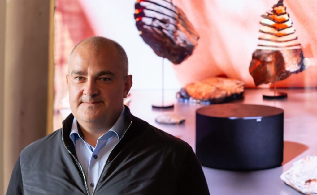Pictured is Aslan Khabliev who took over the traditional German brand Loewe at the end of 2019. He looks into the camera with some Loewe bluetooth speaker in the background. Now Loewe adds Cabasse SA to the portfolio